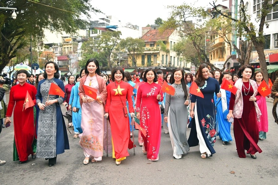 Nguyen Thi Tuyen, president of the Vietnam Women's Union, (fifth from left) joins a parade at Hoan Kiem Lake walking street in Hanoi on March 29.