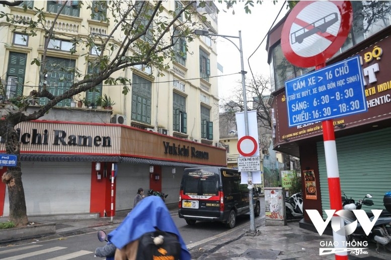 Traffic police patrol key streets to enforce the new restriction, guiding traffic and handling violations.
