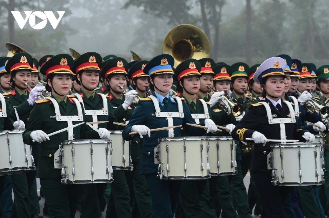 The women’s military band marches during the event
