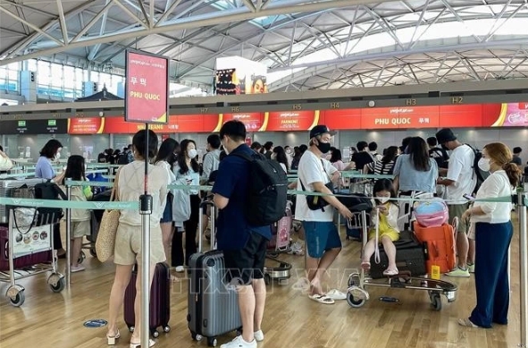 Korean passengers wait to check in at the RoK's Incheon International Airport for a flight to Vietnam's Phu Quoc Island.