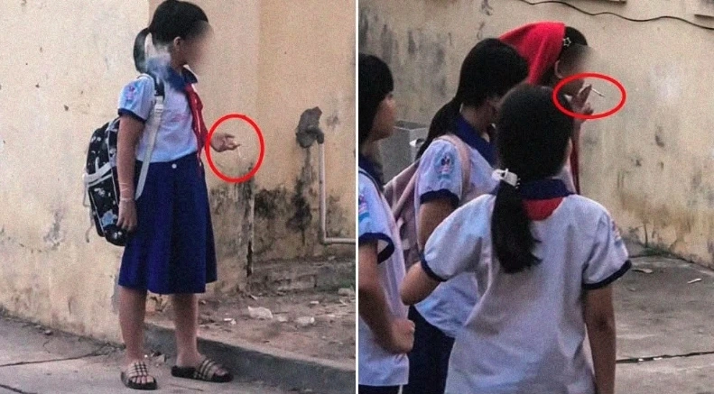 
Cảnh nhóm 5 học sinh nữ trong trang phục học sinh đang hút thuốc lá trong khuôn viên nhà trường