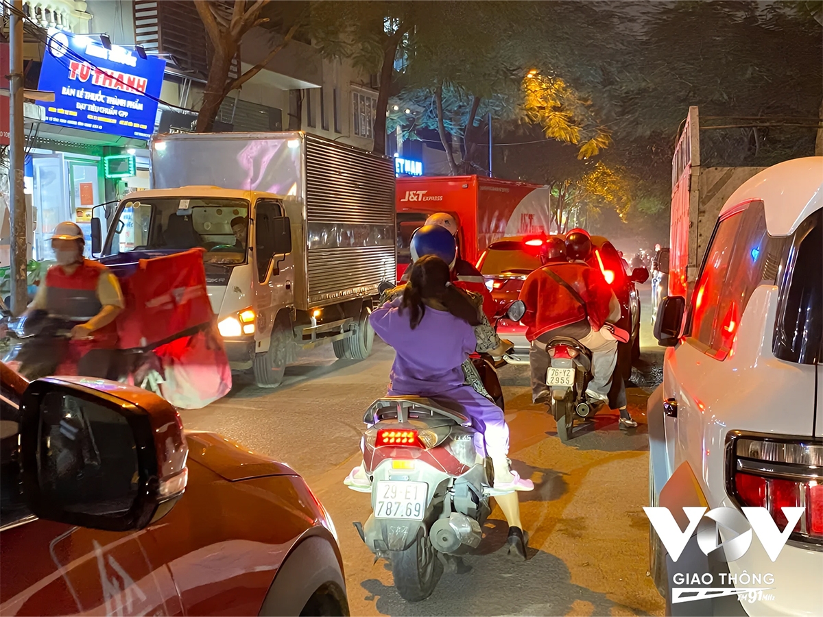 Phần lớn diện tích mặt đường đã bị xe đỗ sai quy định và xe tải vận chuyển hàng hóa chiếm dụng khiến lòng đường bị thu hẹp chỉ đủ cho một chiếc ô tô di chuyển cùng 1 đến 2 chiếc xe máy luồn lách qua những khoảng trống chật chội