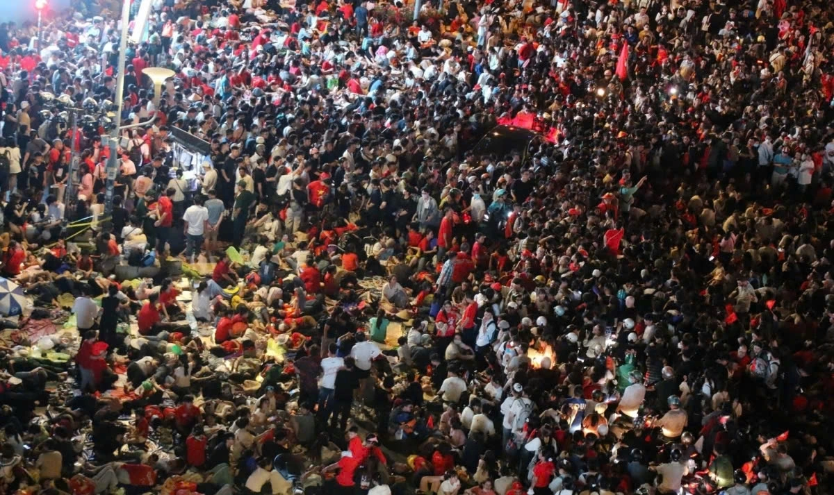 A sea of people wait through the night to witness the parade and procession.
