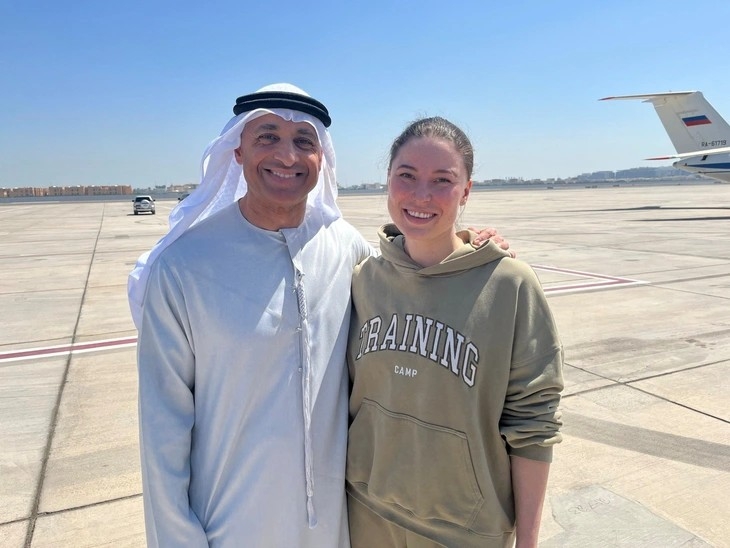 Ông Yousef Al Otaiba, đại sứ UAE tại Mỹ, chụp ảnh với công dân song tịch Nga - Mỹ Ksenia Karelina sau khi được thả tại sân bay Al Bateen ở Abu Dhabi - Ảnh: Reuters
