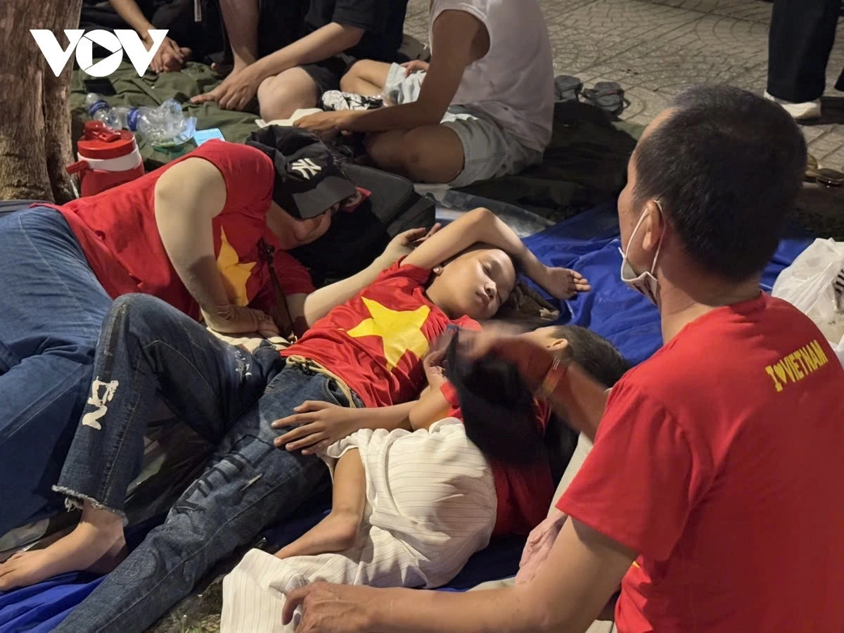 Many people fall into deep sleep on the pavement, waiting for the next morning to watch the parade forces march in celebration of the grand anniversary.