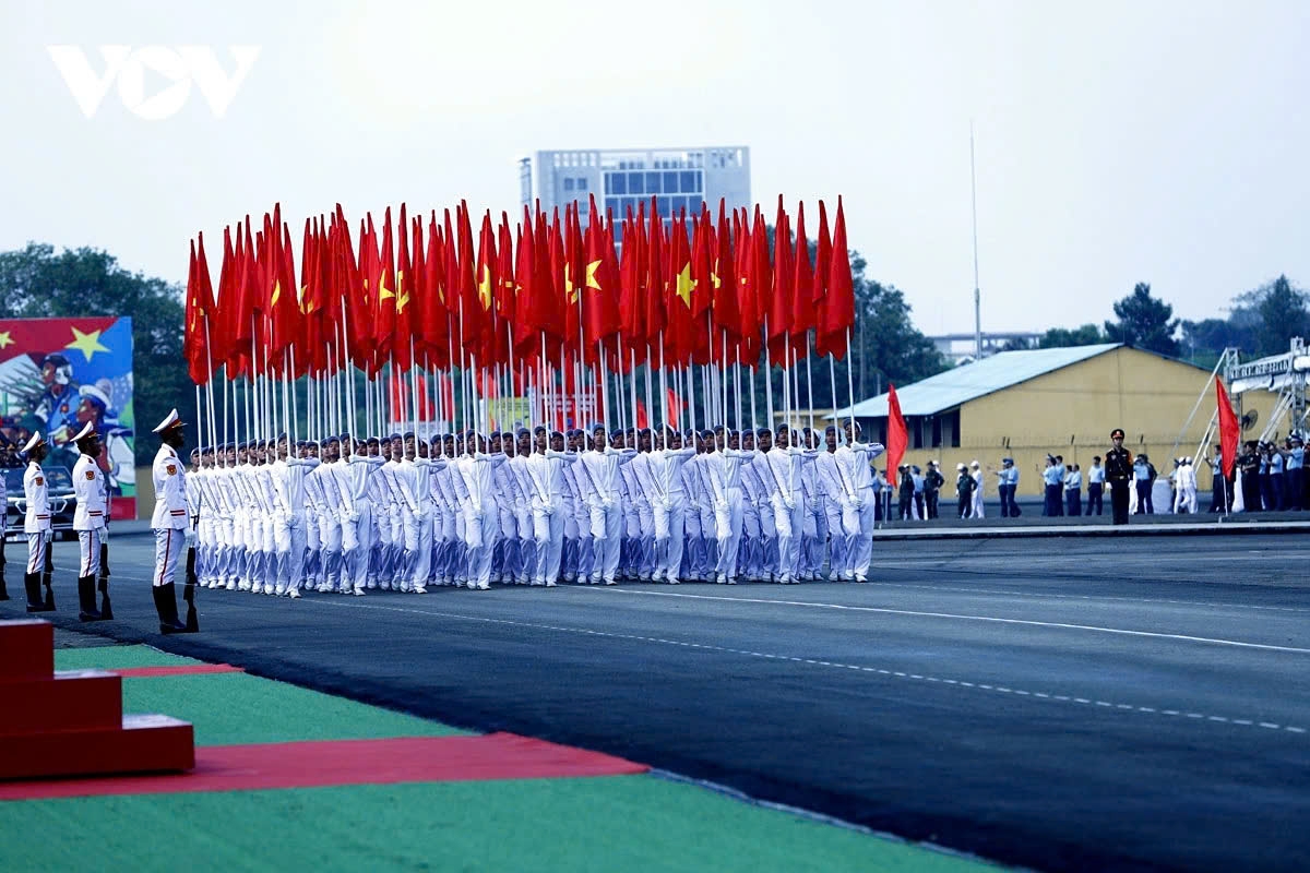 The Party and National flag formation marches through the venue.