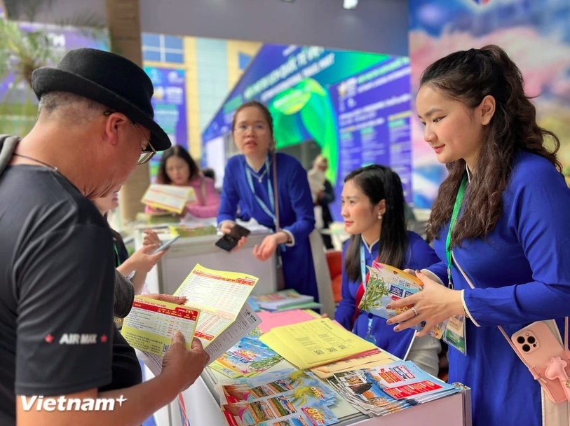 Visitors explore tour information at Vietravel's exhibition booth