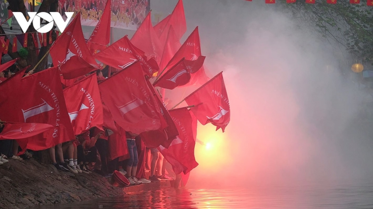 Crowds gather along the banks of the river to watch the competition.