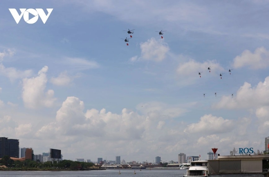 Helicopter team performs a flag-raising display over downtown Ho Chi Minh City
