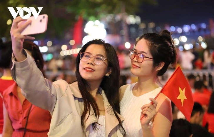 Crowds gather in the city center to watch fireworks and capture the moment