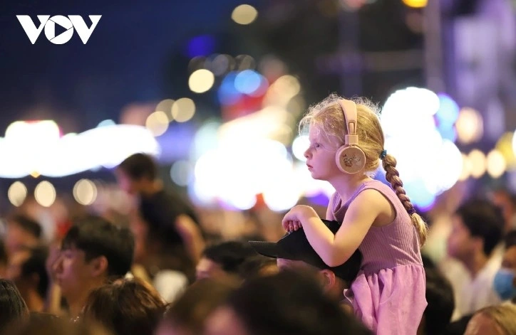 A young foreign visitor watches the fireworks