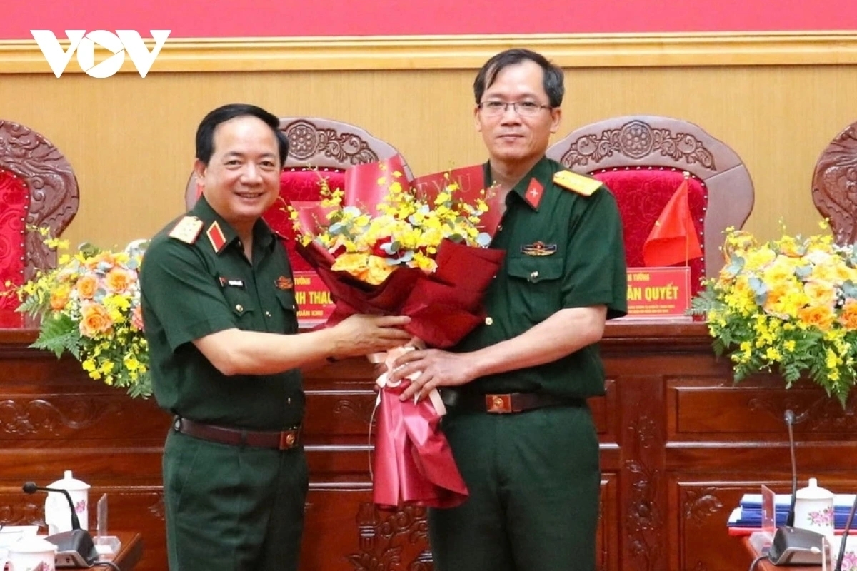 Thượng tướng Trịnh Văn Quyết (bên trái) tặng hoa chúc mừng Đại tá Lương Đình Chung (bên phải), Phó Chính ủy Quân khu 5 nhận nhiệm vụ Chính ủy Quân khu 5