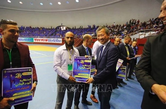 President of the World Vovinam Federation (WVVF) Mai Huu Tin is with outstanding sponsors and coaches at Vovinam Day in Algeria, taking place on May 9. (Photo: published by VNA)