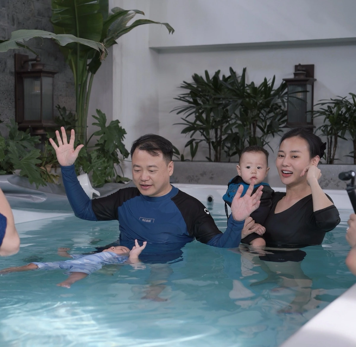 Phương Oanh mời huấn luyện viên chuyên nghiệp về nhà dạy bơi cho cặp song sinh Jimmy - Jenny khi hai bé tròn một tuổi. Ông xã Shark Bình cũng có mặt trong các buổi học của hai con cùng cô. (Nguồn: FBNV)
