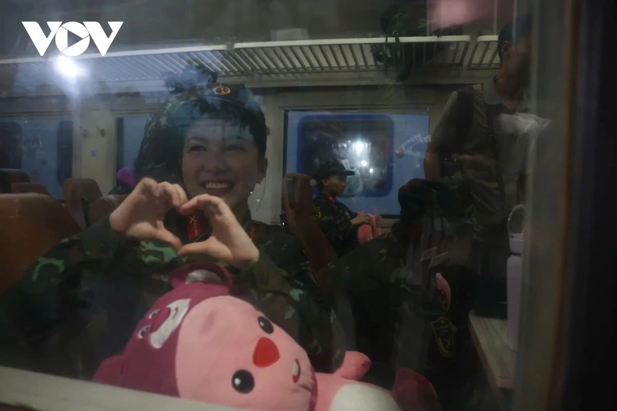 Many soldiers on board the train blow heart-shaped kisses to say goodbye to their loved ones before departure.