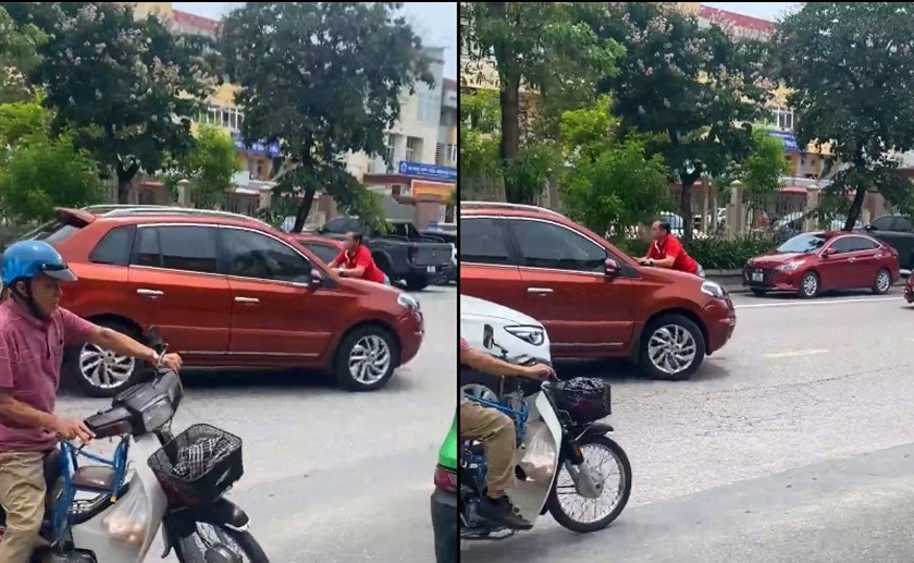 Người đàn ông bám nắp capo ô tô khi xe đang chạy.​​​​​​
