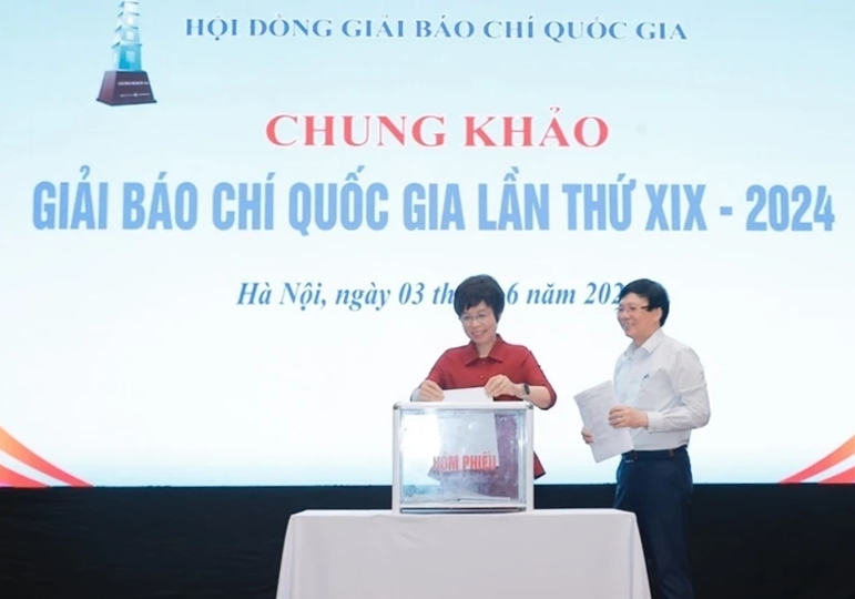 Tổng Giám đốc Thông tấn xã Việt Nam - bà Vũ Việt Trang và nhà báo Hồ Quang Lợi, thành viên Hội đồng chung khảo bỏ phiếu chấm các tác phẩm. (Ảnh: Minh Quyết/TTXVN)