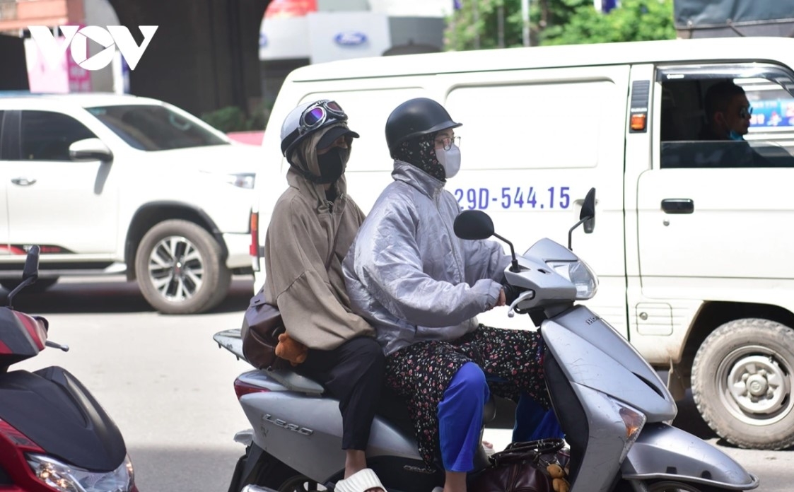     Many residents bundle up in layers and masks to shield themselves from the scorching sun.