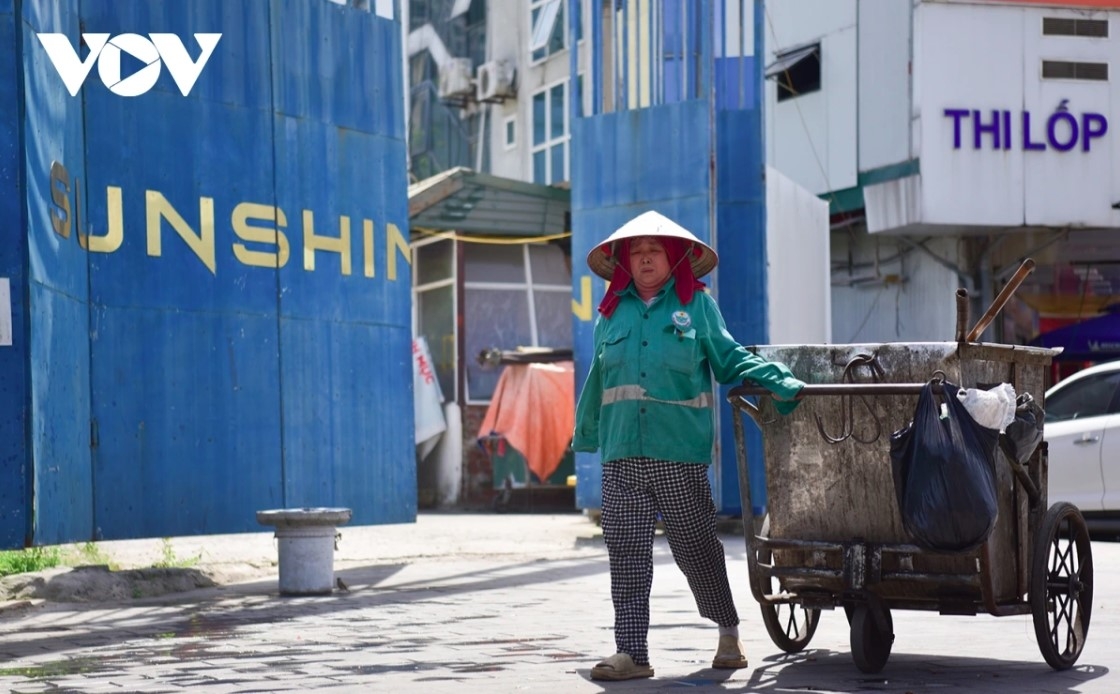 Nguyen Thi Minh Hong, a street cleaner of over ten years, begins her day at 5 a.m. and she feels exhausted by noon.