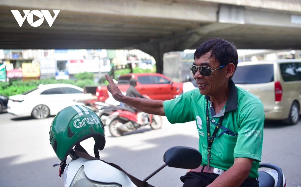 Le Van Tho, a longtime motorbike taxi driver, says “If I find shade, I rest. But it’s hard to skip work as I still need the income.”