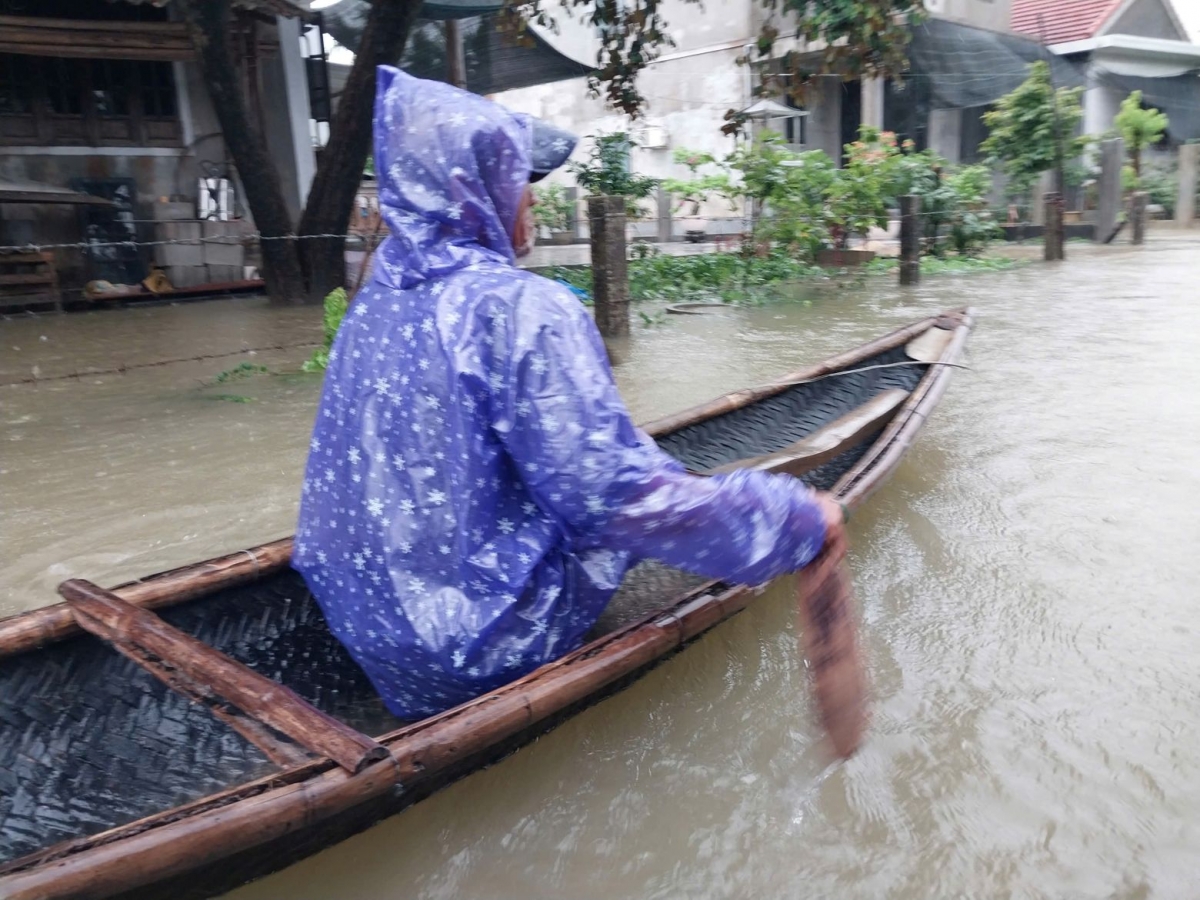 Người dân dùng thuyền đi lại trong mưa lụt ở Huế