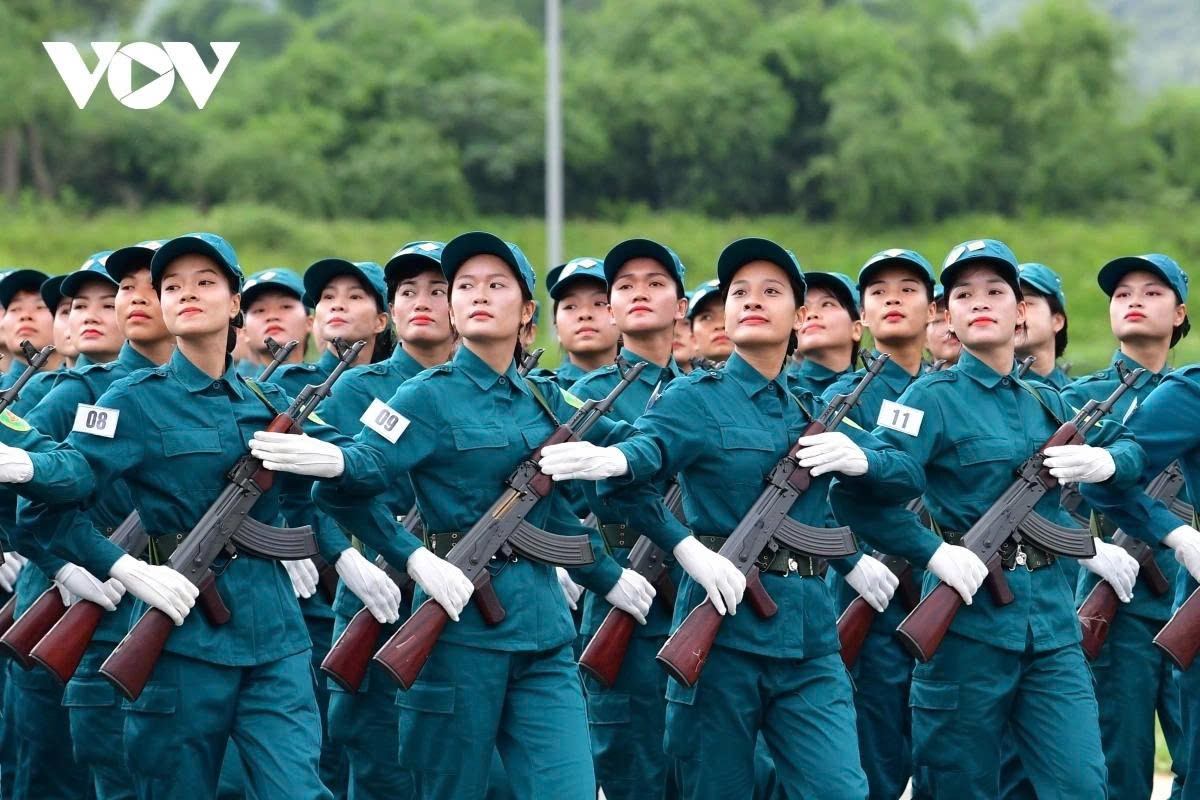 A unit of female self-defense militia participates in the rehearsal, demonstrating grassroots involvement in national defence.