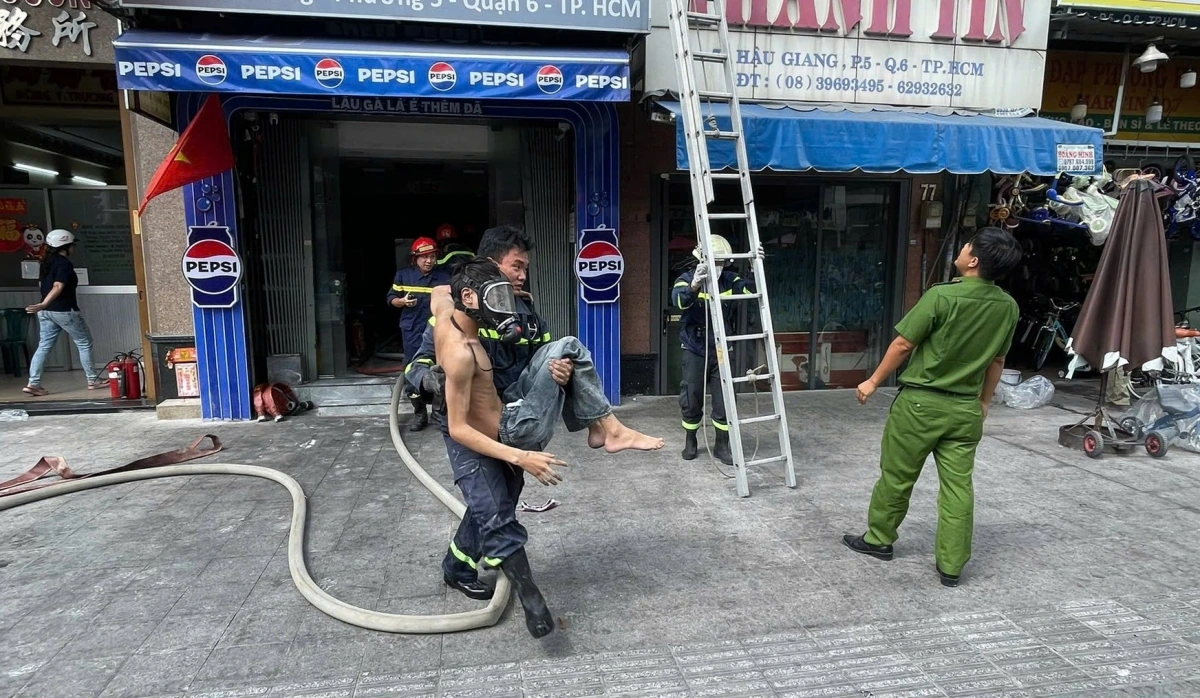 Lực lượng chức năng kịp thời cứu thoát nạn nhân bị kẹt trong đám cháy.