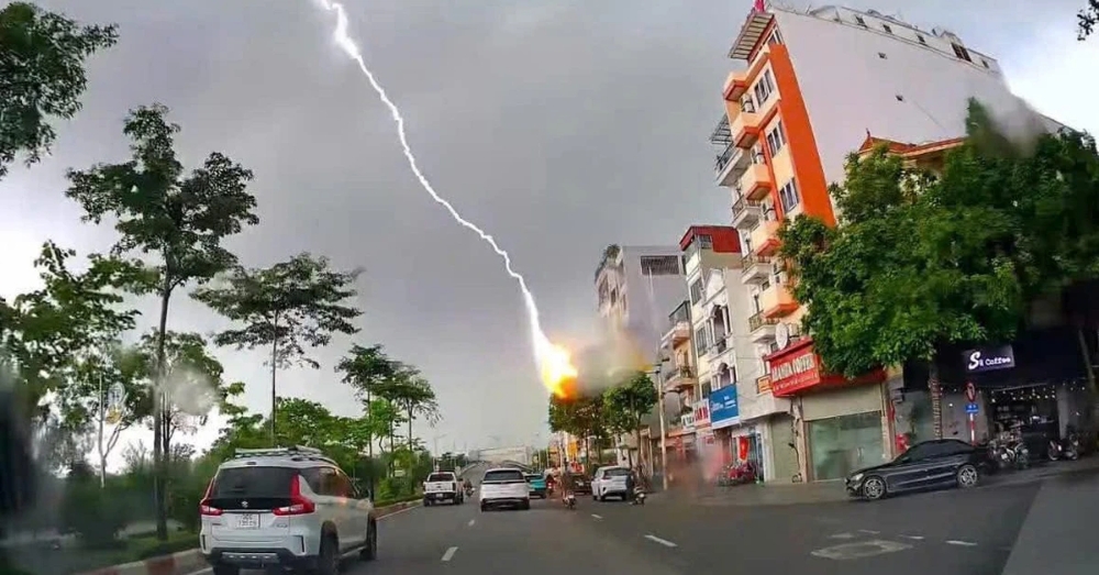 Tia sét đánh xuống một ngôi nhà cao tầng tại Hà Nội được người đi đường vô tình ghi lại