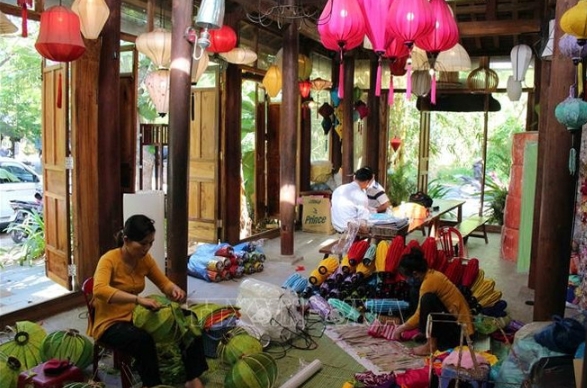 Locals produce lanterns in Hoi An ancient town.