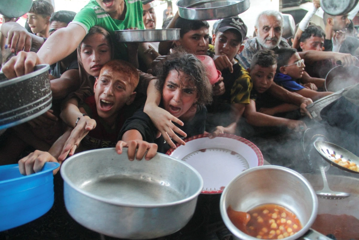 Người dân Gaza chen lấn nhận hàng cứu trợ. Ảnh: Reuters
