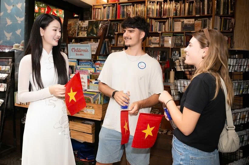 International tourists are delighted to receive Vietnam’s flags while exploring Ho Chi Minh City attractions.
(Photo: VNA)