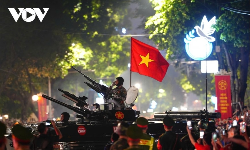 Military convoys march amid cheers and applause from the public