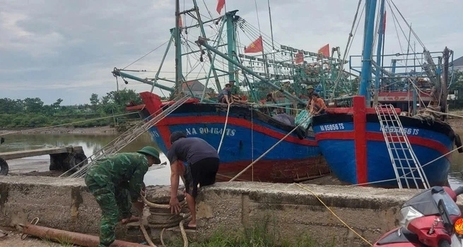 Cán bộ Đồn Biên phòng Quỳnh Thuận, tỉnh Nghệ An hỗ trợ ngư dân neo đậu tàu thuyền.