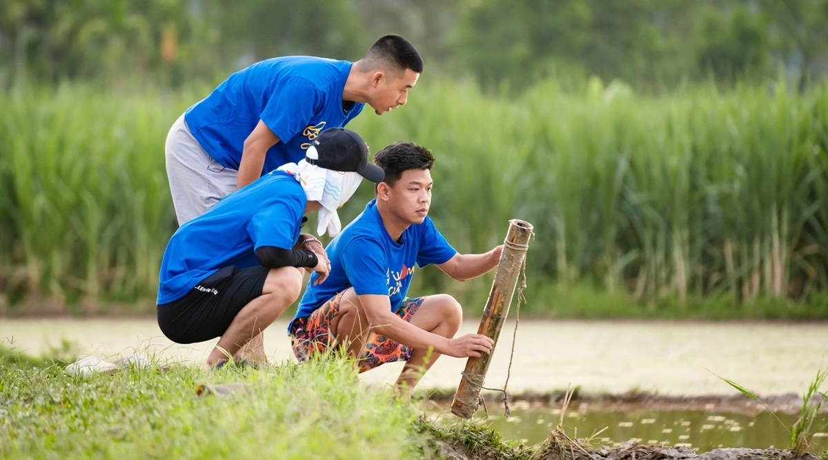 Các ông bố đặt ống bắt lươn. Ảnh: BTC