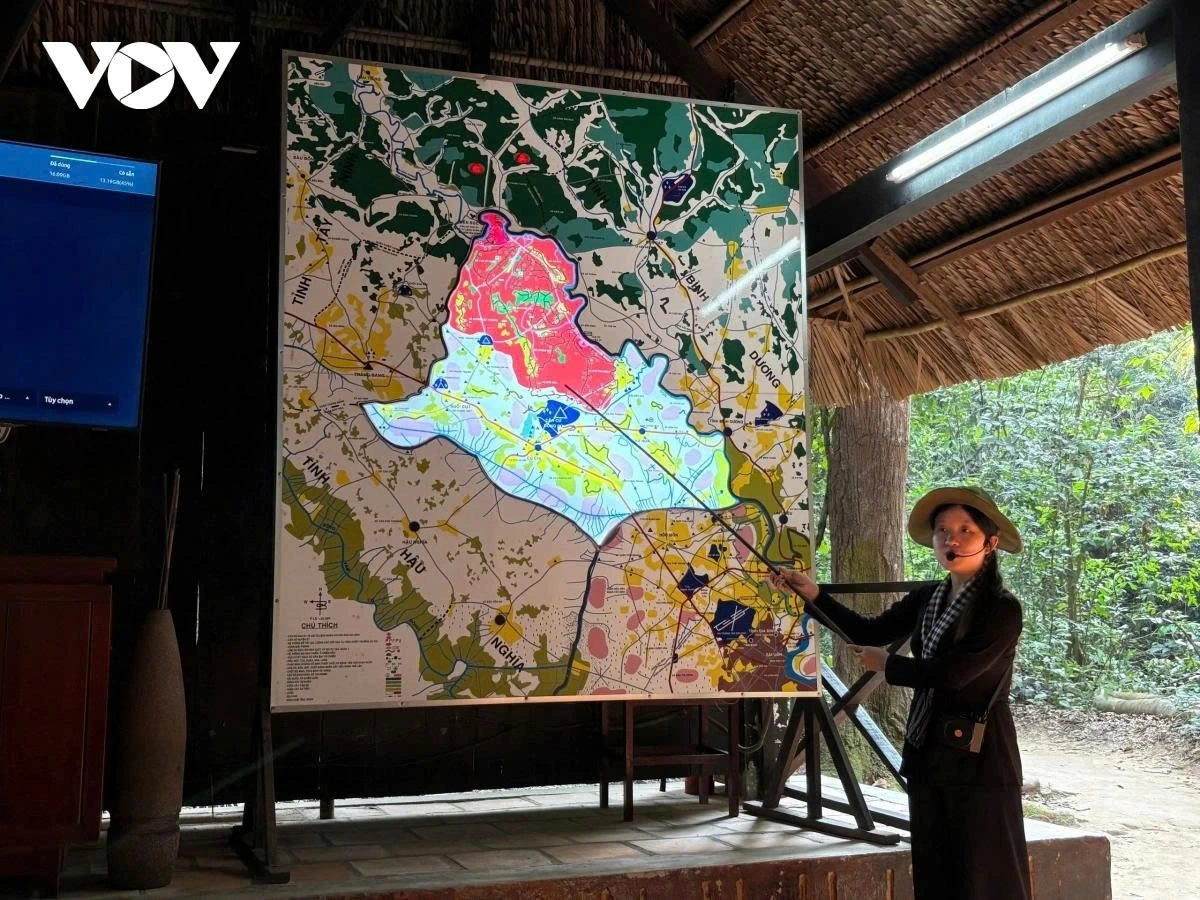 At Cu Chi Tunnels, guides lead visitors through narrow, camouflaged entrances into the underground tunnel network once used by Vietnamese soldiers.