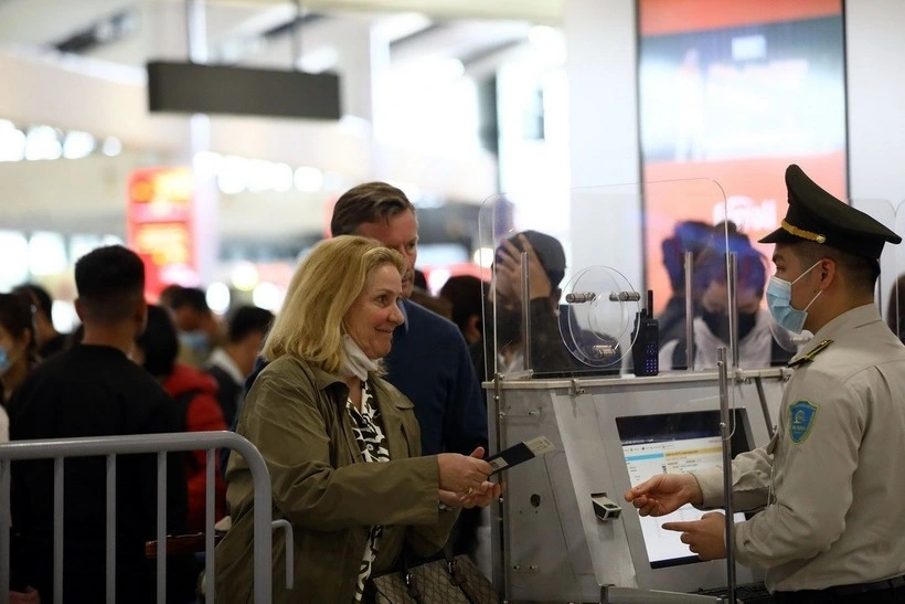 An aviation security official checks passenger information before security screening