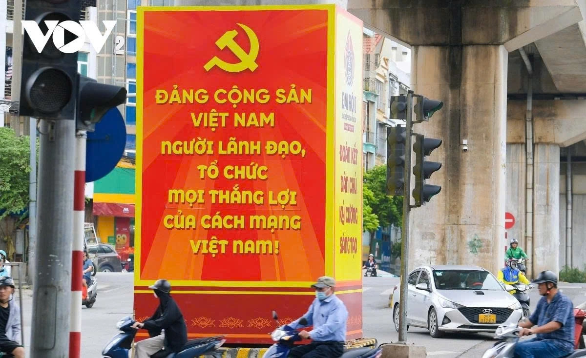 A large-sized poster that reads The Communist Party of Vietnam - the guiding force and organiser behind every victory of the Vietnamese revolution is put up at a crossroads in the capital.