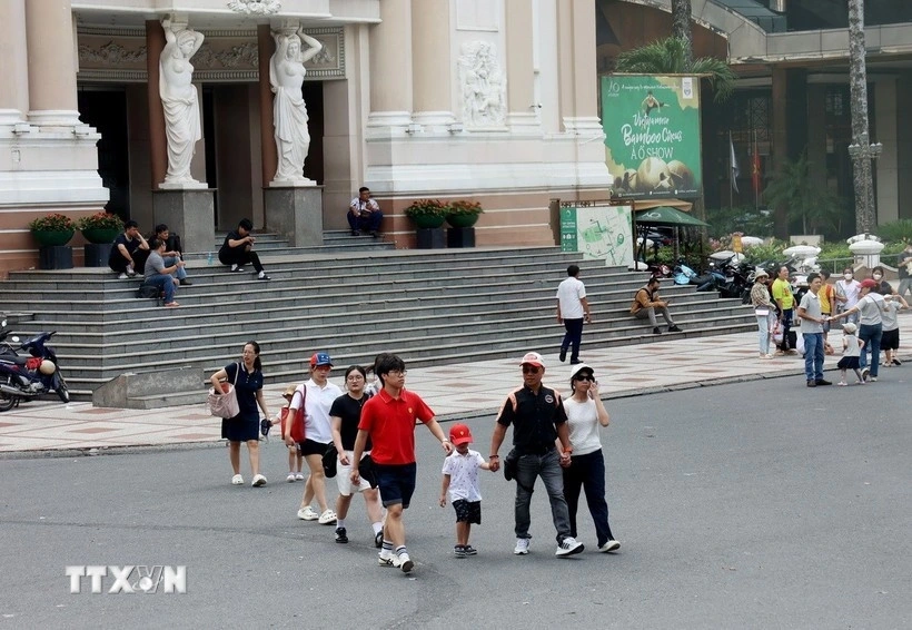 Visitors stroll around Lam Son Square in front of the Ho Chi Minh City Opera House.
