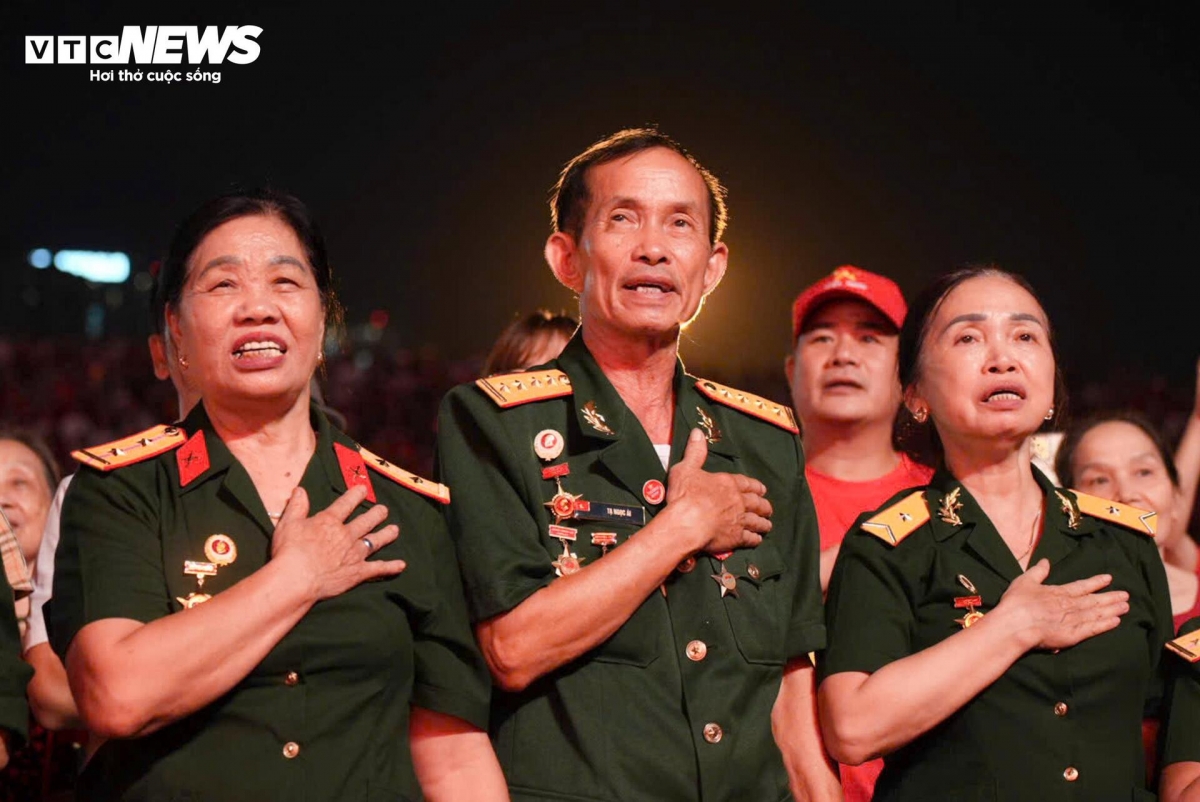 Ta Ngoc Ai, 77, a veteran from Bac Giang, (C) says that standing amid thousands of young people and singing the national anthem together makes him feel the pride of being Vietnamese more deeply than ever.