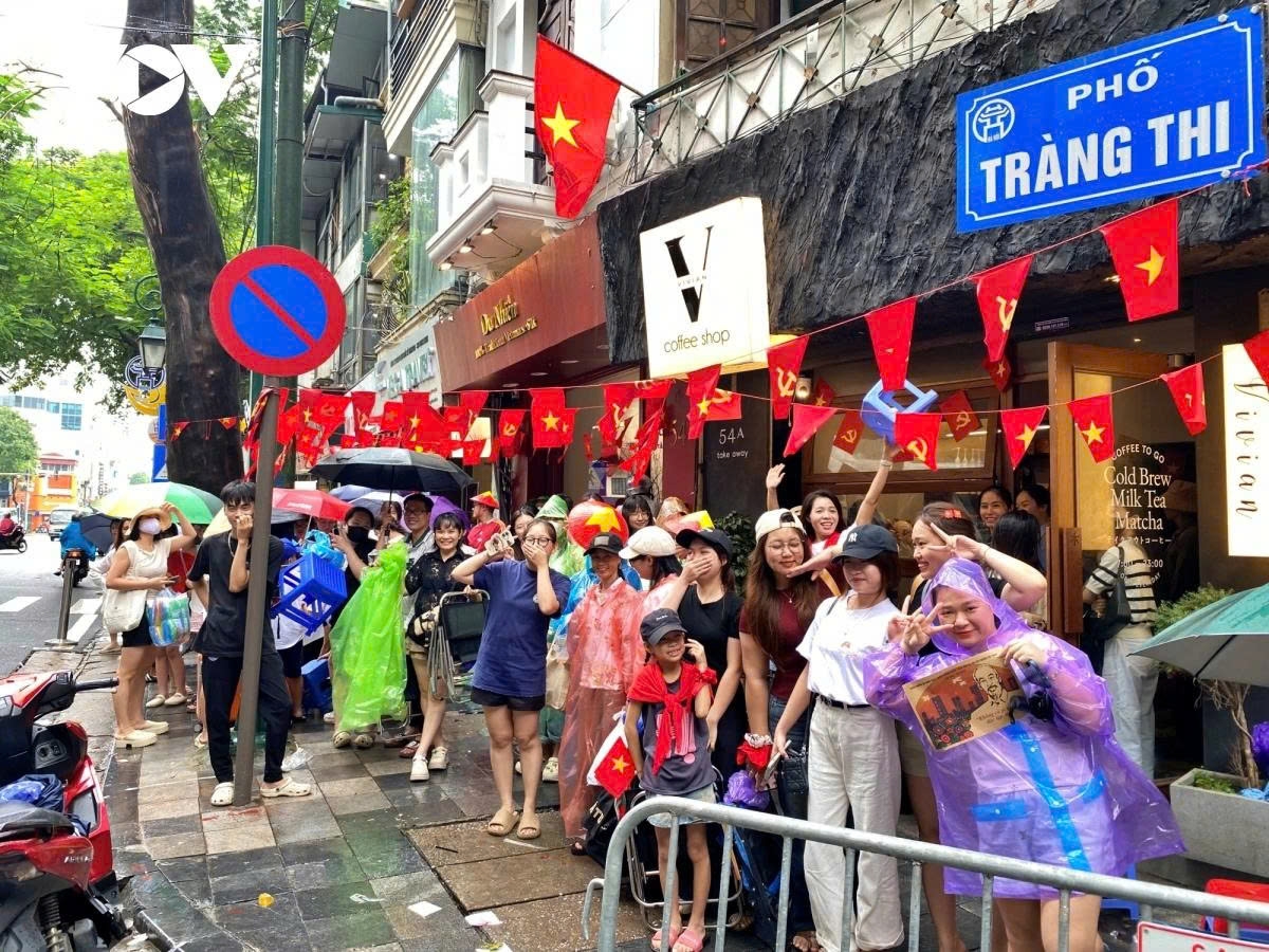 All people join in the lively atmosphere while waiting to watch the soldiers rehearse for the grand celebration.