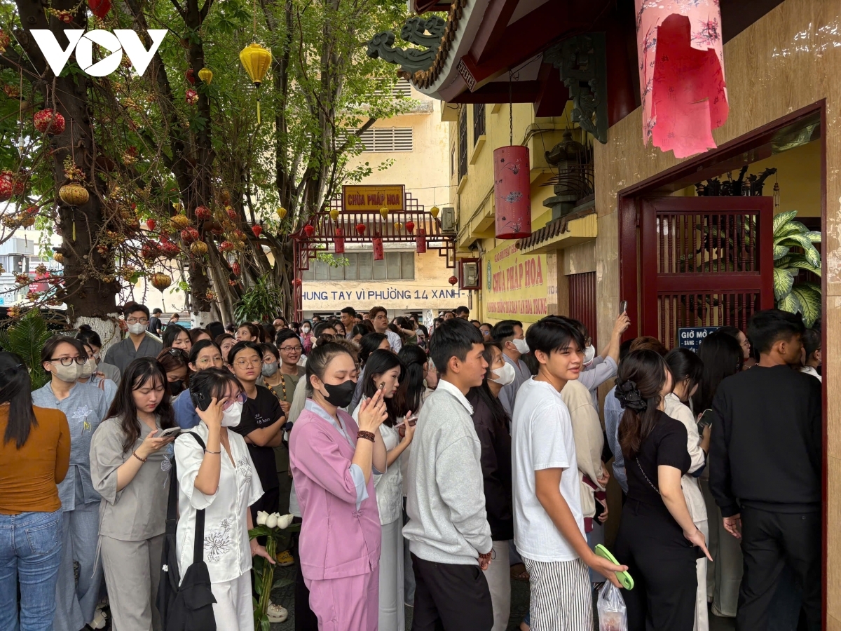Residens line up outside Phap Hoa Pagoda to enter