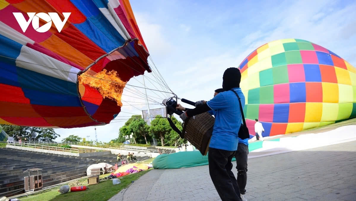 A technician heats the air inside a hot-air balloon.
