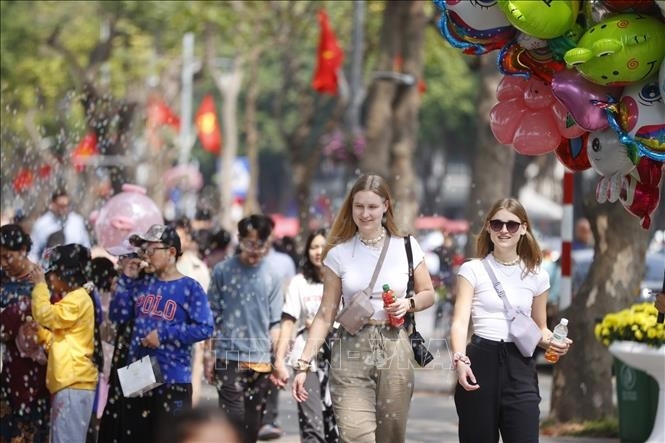 Foreign tourists visit Hoan Kiem Lake in Hanoi.