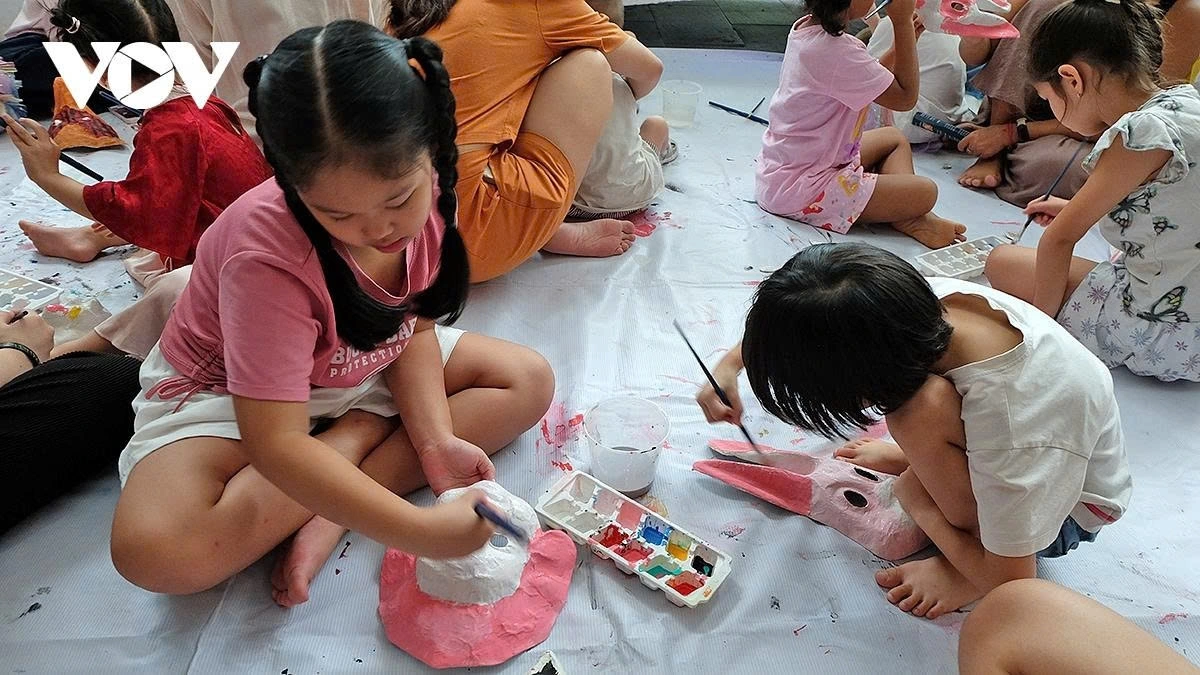 Children enjoy painting papier-mâché masks 
