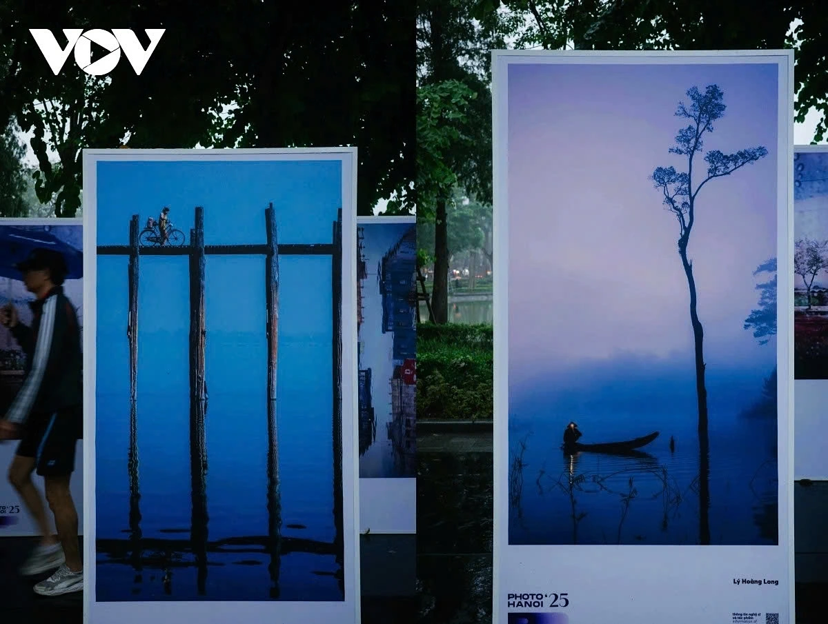 The modern installation blends photography with the urban scenery around Hoan Kiem Lake.