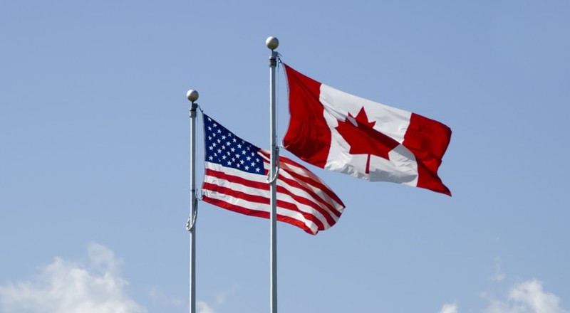 my, canada sap dinh chi hoat dong di lai khong can thiet giua 2 nuoc hinh 1